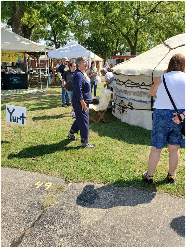  Also at the Michigan Fiber Festival, yurt / felter Linda Johnson-Morke tells the story of her project. Photo: Letty Klein.